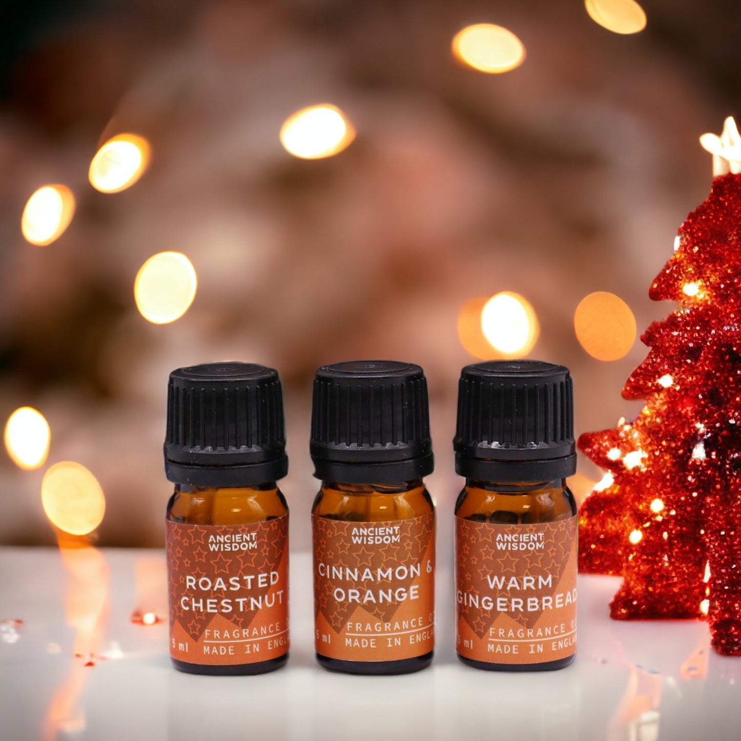 Christmas Fragrance Oil Set - Festive Delights, three small bottles labelled Roasted Chestnut, Cinnamon Orange and Warm Gingerbread by Quintessential Holistic Health Ltd