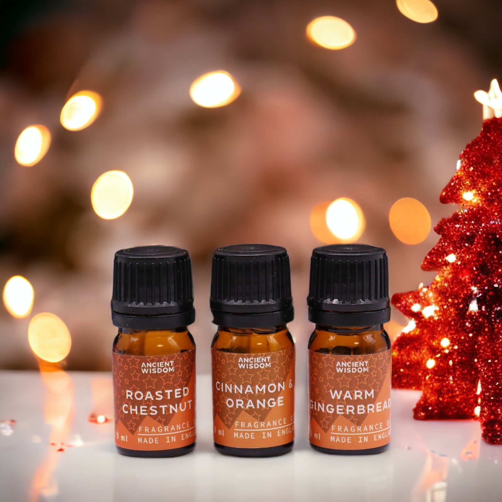 Christmas Fragrance Oil Set - Festive Delights, three small bottles labelled Roasted Chestnut, Cinnamon Orange and Warm Gingerbread by Quintessential Holistic Health Ltd