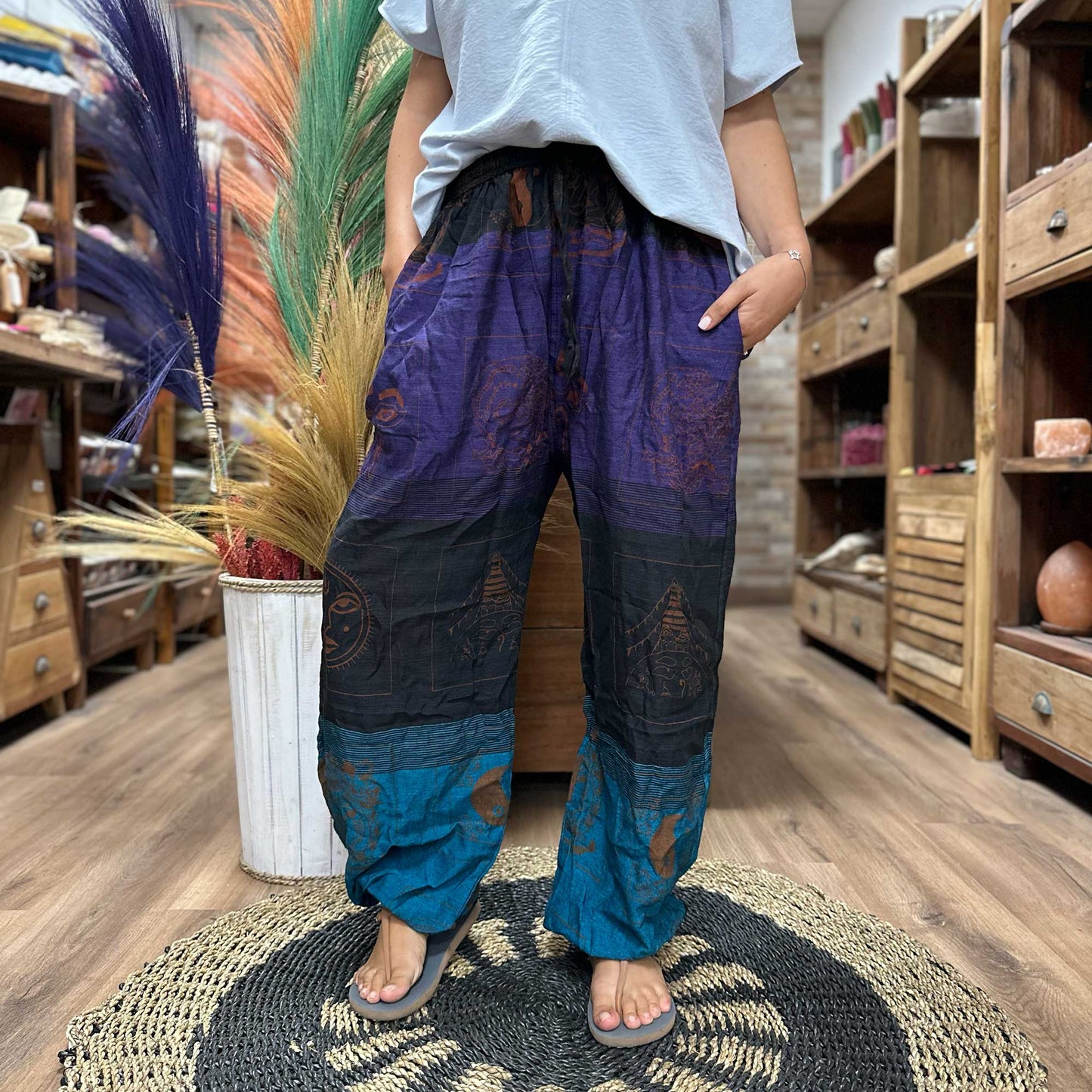 100% Eco-Friendly Cotton Unisex High Cross Style Yoga and Festival Pants - Purple Multicolour / Himalayan Print product packaging on clean background from Quintessential Holistic Health Ltd