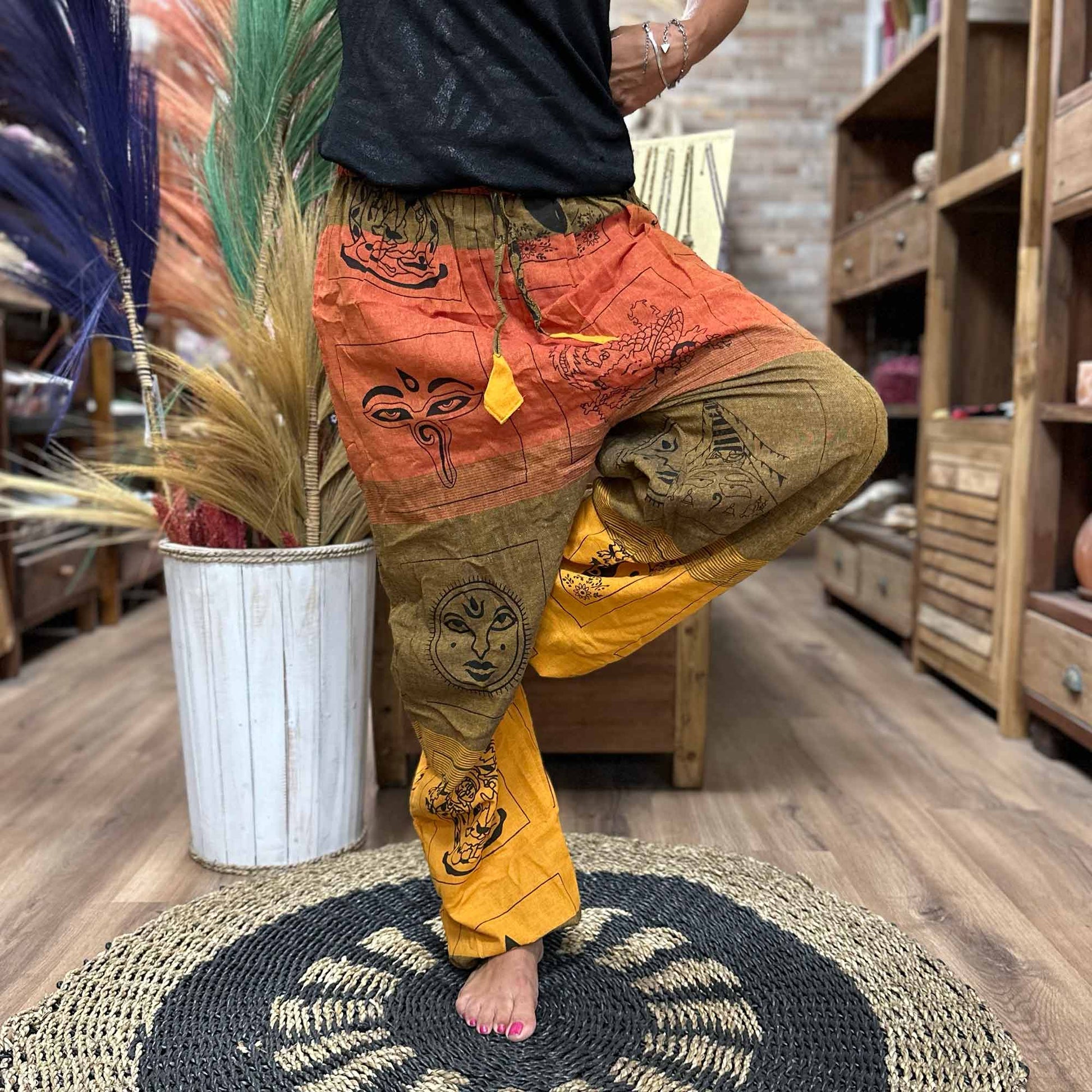 100% Eco-Friendly Cotton Unisex High Cross Style Yoga and Festival Pants - Orange Multicolour / Himalayan Print product packaging on clean background from Quintessential Holistic Health Ltd