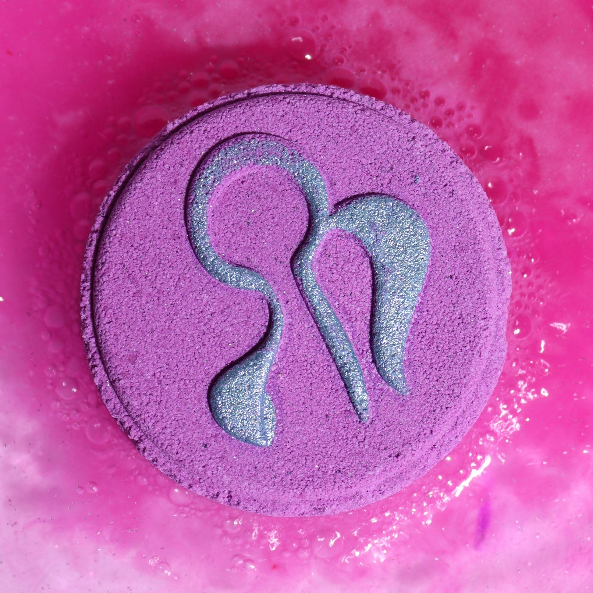 Virgo Zodiac Bath Bomb Fizzers - Tree Agate & Oud - 2 Pack, close-up of a pink and purple fizzer embossed with the Virgo symbol by Quintessential Holistic Health Ltd